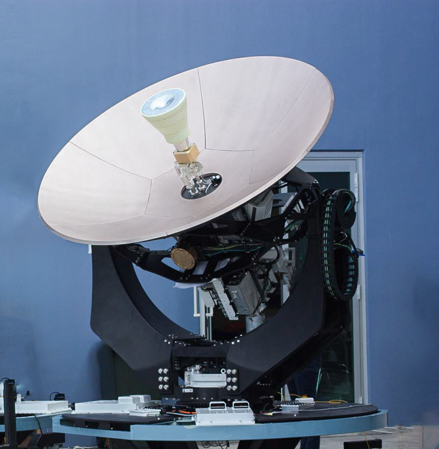 EM Solutions King Cobra satcom with composite azimuth arms (left); and installed and commissioned satcom on a sailing navy vessel (right).